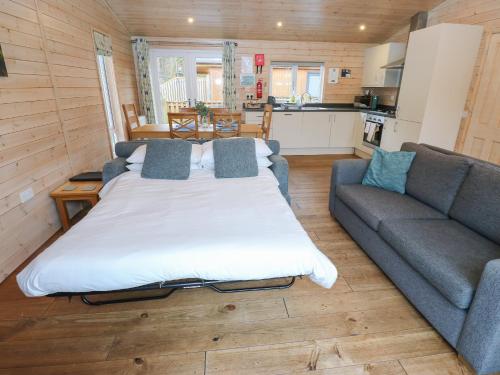 a living room with a bed and a couch at Dovestone Luxury Lodges sleeps 6 - pet free in Oldham