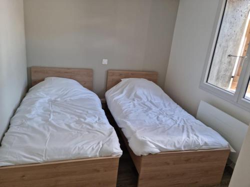 En eller flere senge i et værelse på Appartement montagne