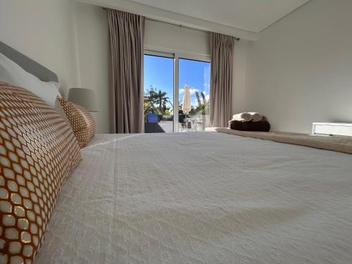 a bedroom with a large bed with a large window at Ocean Dream Apartment- Air Condition in Funchal