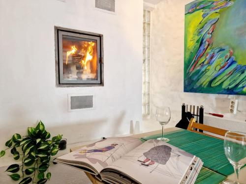 a room with a table with a book and wine glasses at Beautiful condo near Bryggen Balcony Fireplace in Bergen