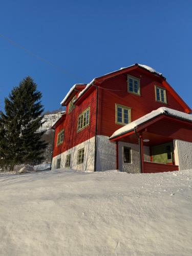 a red barn with snow on the ground in front of it at Sirdal Fjellhytte - Holiday home at Sinnes in Haugen