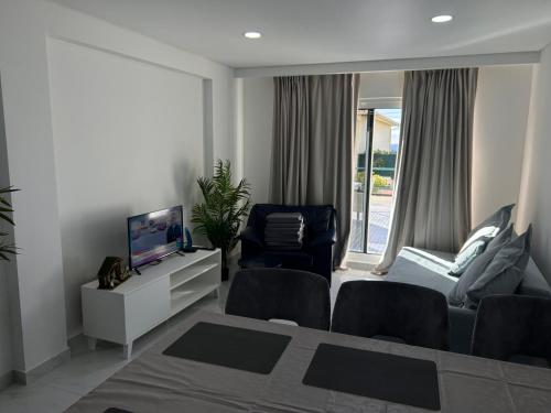 a living room with a bed and a tv and a chair at Ocean Dream Apartment- Air Condition in Funchal