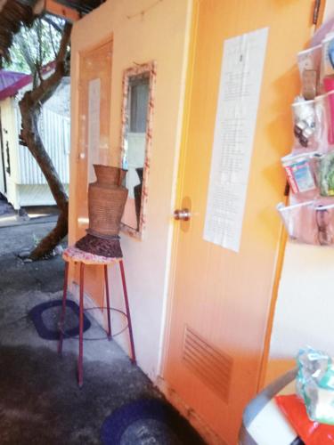 a basket on a stool next to a door at SECLUDED GLAMPING YOGA SAMADHI fan 2 kubos 8 pax in Rimus