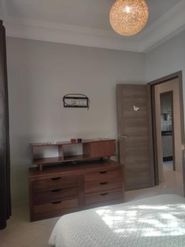 a bedroom with a wooden dresser and a bed at Mounia Moon in Casablanca