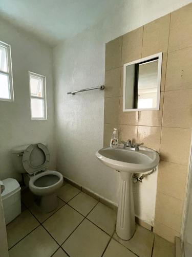 a bathroom with a sink and a toilet at 9 VENATOR House Boutique in Miravalle