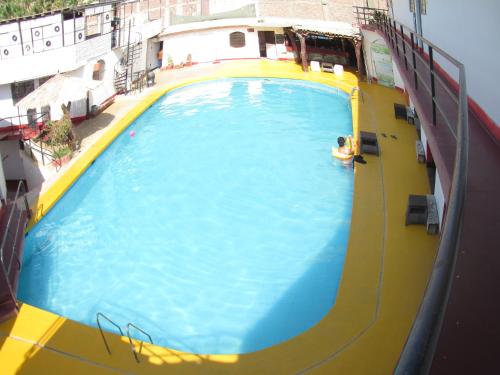 a person swimming in a pool on a cruise ship at Hospedaje snack bar titanic in Ica