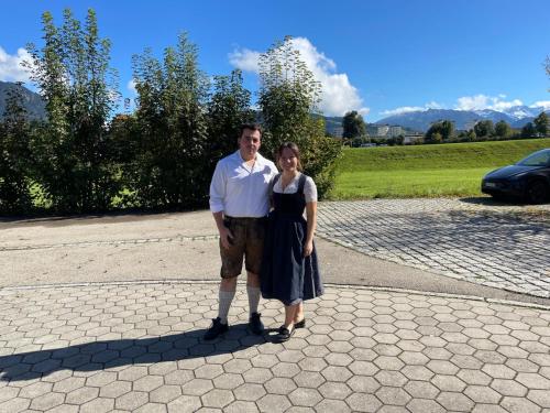 a man and a woman standing on a road at Haus Sylta in Fischen