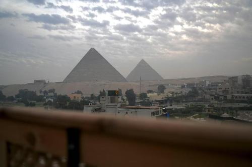 a view of the pyramids of giza from a balcony at Cheristo pyramids view inn in Cairo