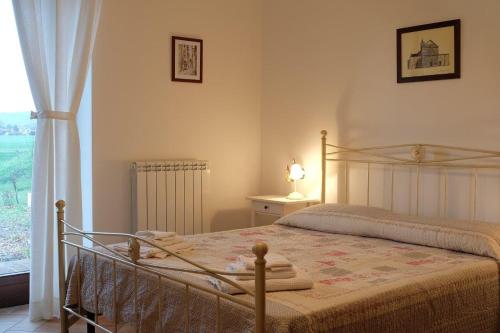 a bedroom with a bed and a window at Sulla Strada di San Francesco in Assisi