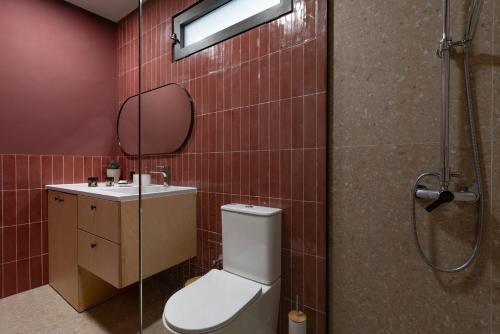 a bathroom with a toilet and a sink and a shower at MOD 15 City Centre in Agios Nikolaos