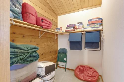 a small room with a bed and a chair at Trails End | Hot Tub, Starlink, Woodstove in Packwood