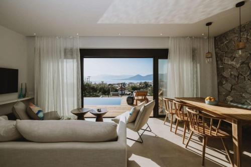 a living room with a couch and a table at Villa Morby in Paleros
