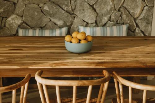 a bowl of fruit sitting on a wooden table at Villa Morby in Paleros