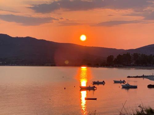a group of boats on a lake at sunset at Villa Morby in Paleros