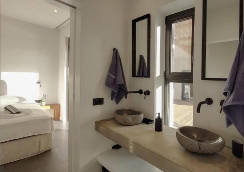 a bathroom with two sinks on a wooden counter at Villa Oneiro in Paleros