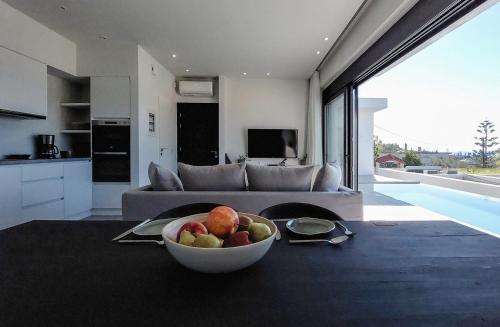 a bowl of fruit on a table in a living room at Villa Pale Rosa in Paleros