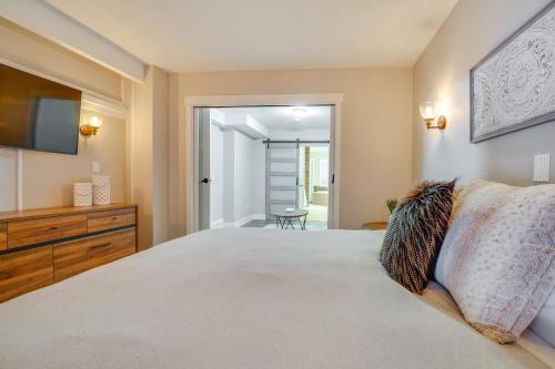 a bedroom with a large bed and a television at The Grand Chelan Group Getaway Pool and Hot Tub in Chelan