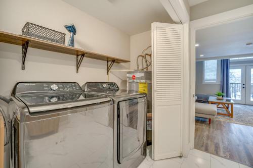 a kitchen with a washer and dryer in a room at The Grand Chelan Group Getaway Pool and Hot Tub in Chelan