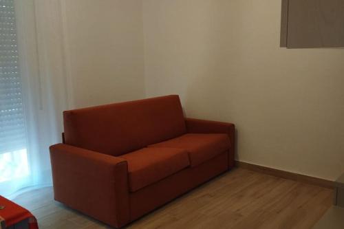 a brown chair in a corner of a room at Casa Guerrina grazioso appartamento in Bologna