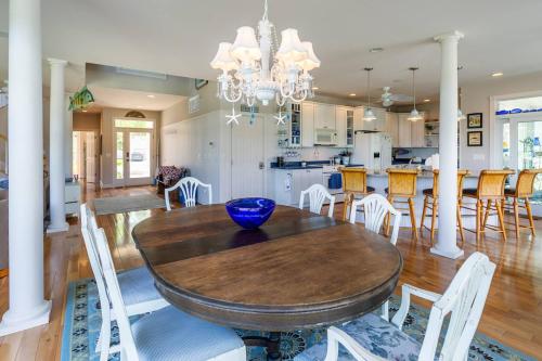 a dining room and kitchen with a wooden table and chairs at A Shore Thing in Chester