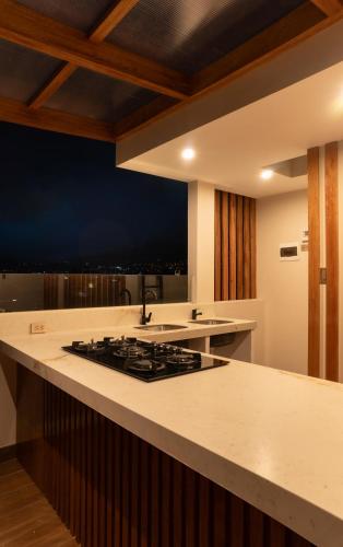 a kitchen with a stove and a counter top at Qasamarca Hotel Boutique in Cajamarca