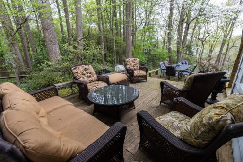 a patio with couches and chairs and a table at Riverfront Hangar in Crownsville