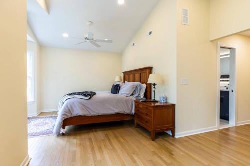 a bedroom with a bed and a table with a lamp at Riverfront Hangar in Crownsville