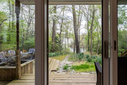 a sliding glass door looking out into a garden at Riverfront Hangar in Crownsville