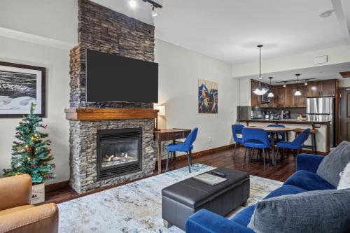 a living room with a fireplace and a tv at Stoneridge Mountain Resort Condo managed by Little Sister Getaways in Canmore
