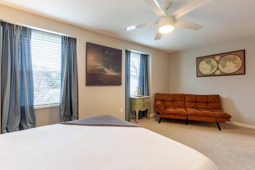 a bedroom with a bed and a couch and windows at Liberty Call in Arnold
