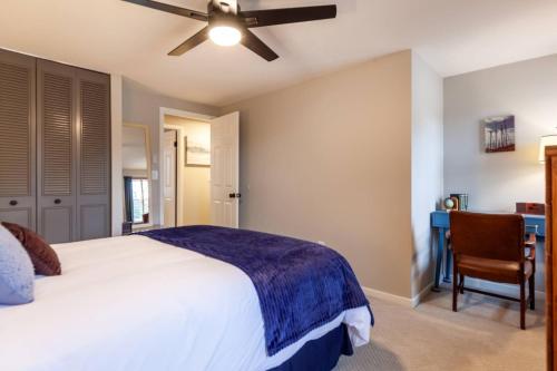 a bedroom with a bed and a desk and a ceiling fan at Liberty Call in Arnold