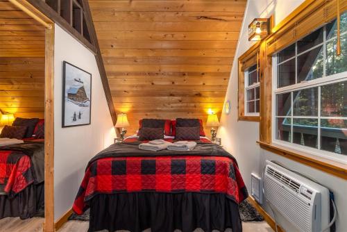 a bedroom with a bed in a room with wooden walls at Wonderland Chateau in Packwood