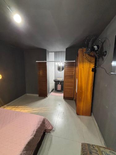 a room with a bedroom with a bed and a room with at Recanto da Cachoeira RJ in Magé