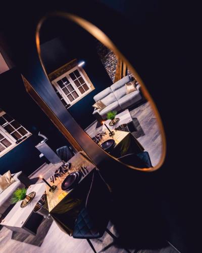 a reflection of a table in a rear view mirror at love room l'écrin du désir in Aubers