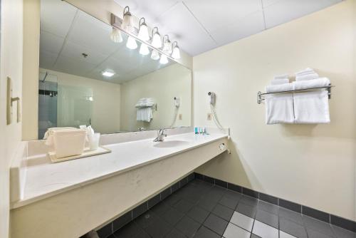 a bathroom with a sink and a large mirror at Bayshore Resort At Put-In-Bay in Put-in-Bay