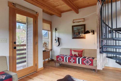 a living room with a couch and a staircase at Ravenwood in Packwood