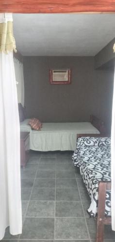 a small bedroom with a bed and a window at Inti Mayu in Villa Cura Brochero