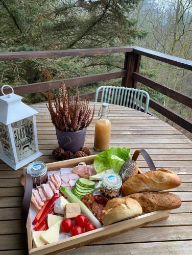 a tray of food on a table with bread and cheese at Zebikuckó vendégház in Zebegény