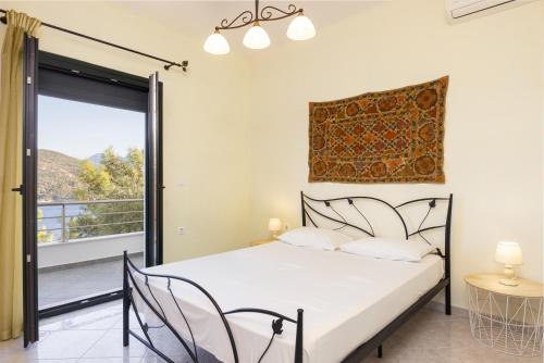 a bedroom with a bed and a balcony at Ano Platanaki in Kerveli