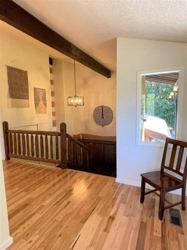 an empty living room with a chair and a window at Valley View Cabin in Packwood