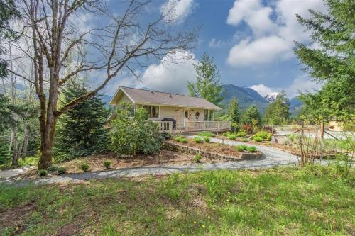 a home in the mountains with a pathway leading to a house at The Alpenhaus in Packwood