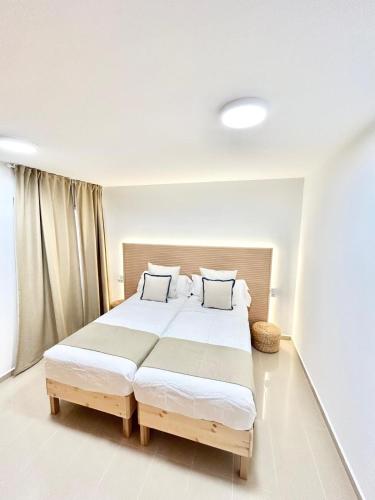 a bedroom with a large bed with two pillows at VV Canary Islands 1 in San Miguel de Abona