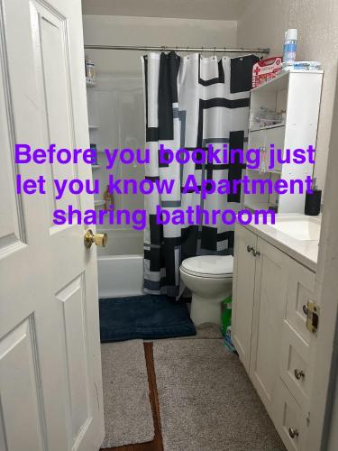 a bathroom with a tub and a toilet and a sink at Apartment sharing bathroom #2 in Anchorage