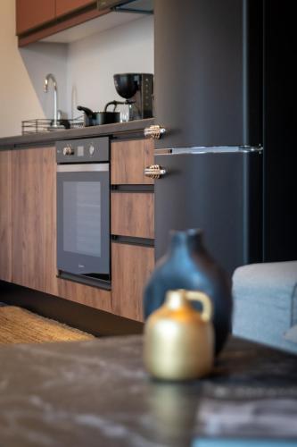 a kitchen with a stainless steel refrigerator and a table at MOD 15 City Centre in Agios Nikolaos