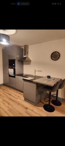 a kitchen with a table in the middle of a room at Cozy town apartment in Claremorris