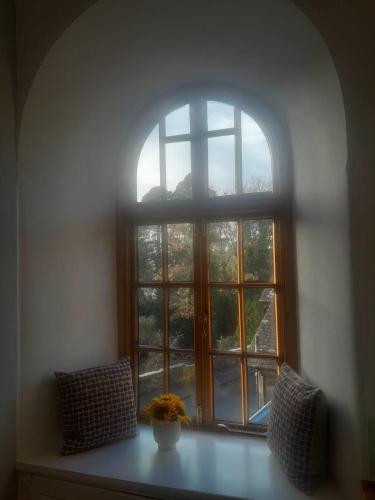 an open window with a vase of flowers on a table at Doune 3 Outlander Apartment 1st floor in Stirling
