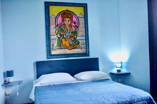 a bedroom with a painting on the wall above a bed at B&B Villa Sabrina in Arezzo