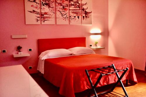 a red bedroom with a bed with a red bedspread at B&B Villa Sabrina in Arezzo
