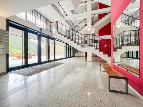 a hallway with a staircase in a building at Barthe Holidays I Apartamento Moderno en Arinsal 4PAX a pie de pistas I Balcón con vistas impresionantes al valle y parking I Guineu in Arinsal