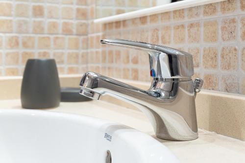 a bathroom sink with a faucet on a counter at Con Vistas a la Montaña, Parking y WiFi in El Tarter
